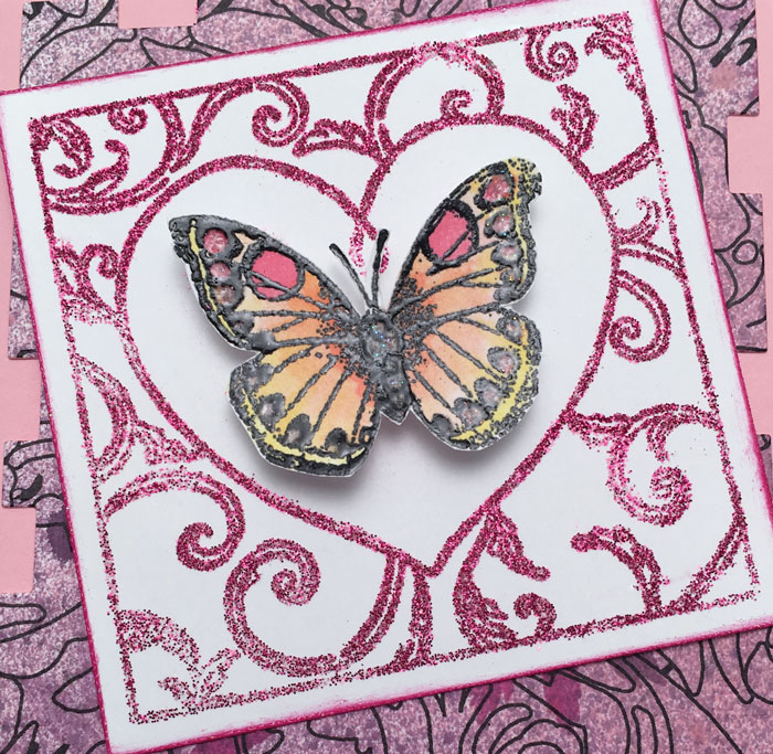Red Glitter applied to a valentine in an intricate image by using The Essential Glue Pad and stamp.