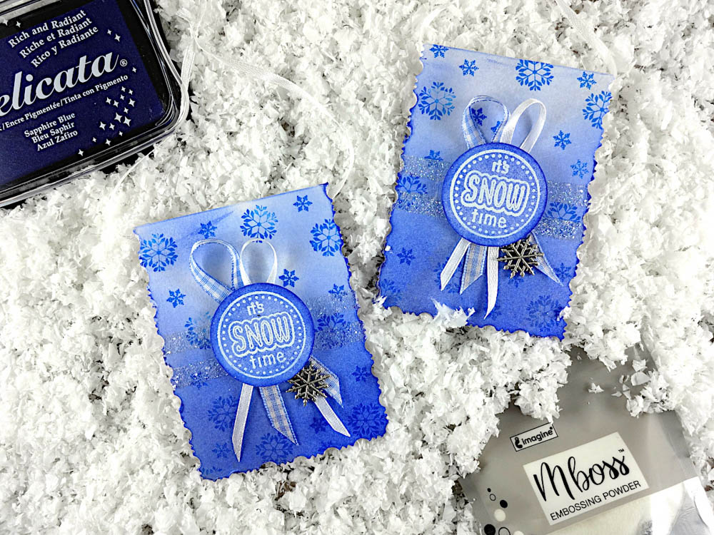 Choose Delicata Sapphire Blue for a deep, shiny color result on gift tags that can be attached to any winter gift. The Mboss white embossing powder, in contrast with the deep blue stamped snowflake, enhances the sentiment.